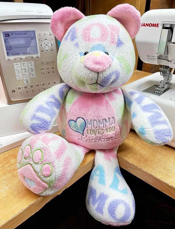 Angie Wade used a fleece baby blanket to make a fun embroidered version of the Keep Me Keepsake Bear. I designed this bear especially for this type customization using embroidery or heat transfer vinyl (HTV). The pattern pieces show you exactly where to center your design hoops to center content on the tummy, foot pads, arms and sides. 